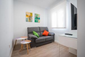 a living room with a couch and a table at QH Avenida de la Constitución in Granada