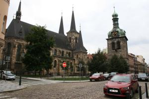 a red car parked in front of a large building at Apartment Marilyn in Prague