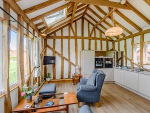 a living room with a table and chairs in a building at Blackwell Barn in Raydon