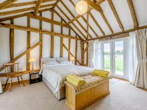 een slaapkamer met een bed en een groot raam bij Blackwell Barn in Raydon