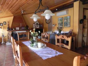 a dining room with a large wooden table with chairs at la buhardilla de mi casa in Alcañiz