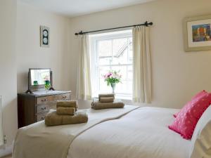a bedroom with a large bed with two pillows on it at Bondgate in Helmsley