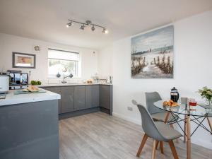 a kitchen and dining room with a table and chairs at Herons Haven - Uk31452 in Paignton