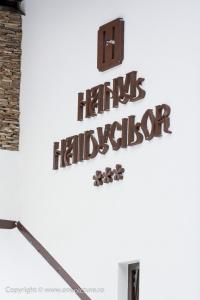 a sign on the wall of a building with the words harris hallovation at Hanul Haiducilor in Obarsia-Lotrului