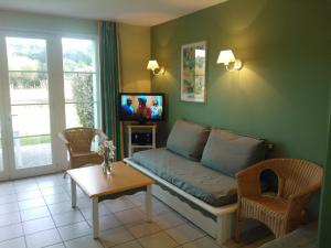 a living room with a couch and a tv at 3 bedrooms Holiday Home Golf Resort Port-Bourgenay in Talmont