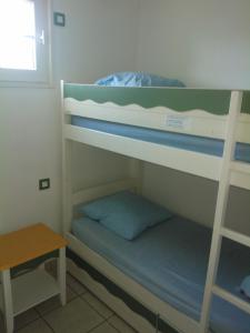 a room with two bunk beds and a table at 3 bedrooms Holiday Home Golf Resort Port-Bourgenay in Talmont