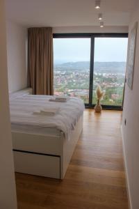 een slaapkamer met een bed en een groot raam bij Villa Wineyard - VinoGrad in Banja Luka