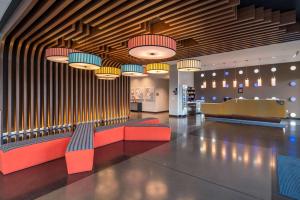 a lobby with benches and pendant lights at GLō Best Western Lexington in Lexington