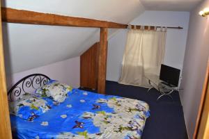 a bedroom with a bed with a blue comforter at Casa Sasca Montana in Sasca Montană +22 photos