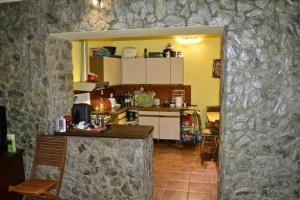 a kitchen with a stone wall at Casa Sasca Montana in Sasca Montană