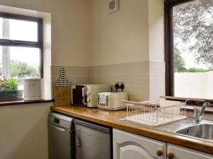 a kitchen with a counter top with appliances on it at Carters Rest - Uk30884 in Abererch