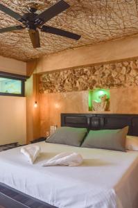 a bedroom with a large white bed with a ceiling at Habitaciones Colonial Zaci in Valladolid
