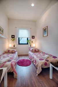 a bedroom with two beds and a window at Apartment Breeze in Bratislava