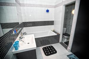 a bathroom with a sink and a bath tub at Apartment Breeze in Bratislava