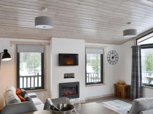 a living room with a couch and a fireplace at Cruachan in Etteridge