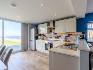 a kitchen with a view of the ocean at Hunroe Brow in Reighton