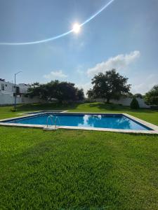 uma piscina no meio de um campo de relva em Punta del Sol Catarinas em Temixco