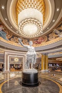 a statue in a lobby with a large ceiling at Caesars Palace Hotel & Casino in Las Vegas