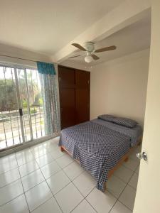 Schlafzimmer mit einem Bett und einem Deckenventilator in der Unterkunft Punta del Sol Catarinas in Temixco