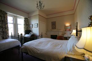 Säng eller sängar i ett rum på Bellevue Guest House