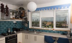 a kitchen with a sink and two windows at Bright and spacious 1 bed flat in Camberwell in London