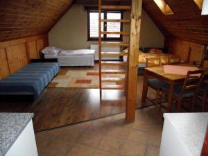 a bedroom with a bunk bed and a table in a room at Zulu Cafe Apartment in Rétság