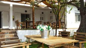 a picnic table with a bucket of flowers on it at Smaragdi Studios in Pefkari