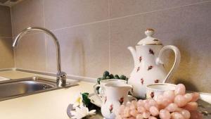 a kitchen counter with cups and a tea pot and grapes at Smaragdi Studios in Pefkari +77 photos