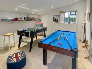 a living room with a pool table and a table at Herrock View in Evenjobb