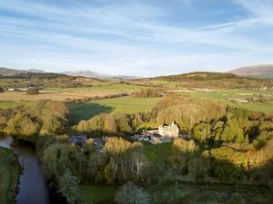 an aerial view of a house on a hill next to a river at East Lodge in Creebridge