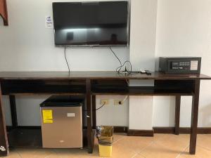 a wooden table with a television on top of it at SKY INN in Caye Caulker