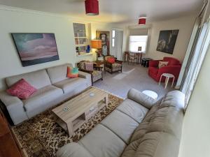 a living room with a couch and a table at The F Project Residence - whole house in Warrnambool