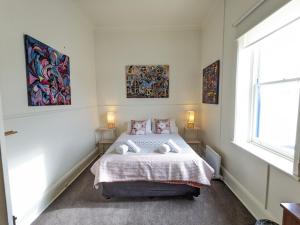 a bedroom with a bed with two pillows on it at The F Project Residence - whole house in Warrnambool