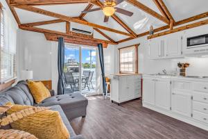 a kitchen and living room with a couch and a table at Aqua Lodges at Coconut Cay Rv and Marina in Marathon