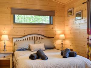 a bedroom with a bed with two pillows on it at Oak Lodge - Uk30005 in Lindal in Furness