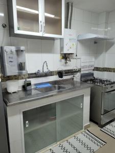 a kitchen with a sink and a counter top at Couto Lauredo Ap in Rio de Janeiro