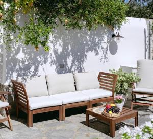 - un canapé sur une terrasse avec 2 chaises et une table dans l'établissement Aqua Holiday Apartments, à Procida