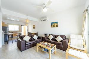 a living room with a couch and a table at Great Kings Resorts in Protaras