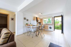 a kitchen and living room with a table and chairs at Great Kings Resorts in Protaras