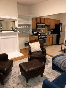a living room with two chairs and a kitchen at Home away from Home! A place to focus and relax! in Cambridge