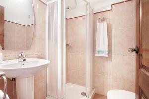 a bathroom with a shower and a sink at Apartaments Plaça Major in Santa Pau
