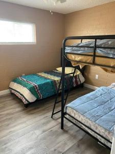 a room with two bunk beds and a window at #2 bedroom cozy SUITE, 1 min walk to the beach # in Bullhead City
