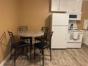 a kitchen with a table and chairs and a white refrigerator at #2 bedroom cozy SUITE, 1 min walk to the beach # in Bullhead City