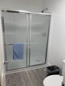 a bathroom with a shower with a blue towel at #2 bedroom cozy SUITE, 1 min walk to the beach # in Bullhead City