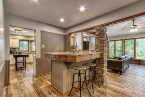 a kitchen and living room with a bar in a house at Powdermill Point Theater Room, Miniature Golf, 560 FREE tickets each paid day! in Sevierville