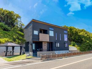 a black house on the side of a road at T.Square in Akashi