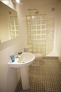 a bathroom with a sink and a toilet at Sol y Mar Surf Camp in Corralejo