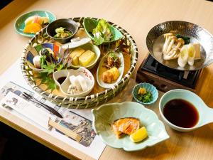 a table with plates of food and a bowl of soup at Hakone Onsen Yuyado Yamanoshou in Hakone