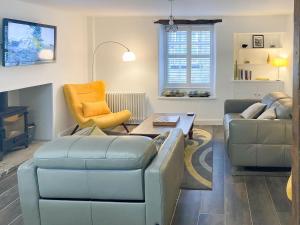 a living room with two couches and a table at The White Cottage in Gargrave