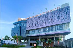 a hotel building with a sign on top of it at Trio Azana Style Kebumen in Kebumen
